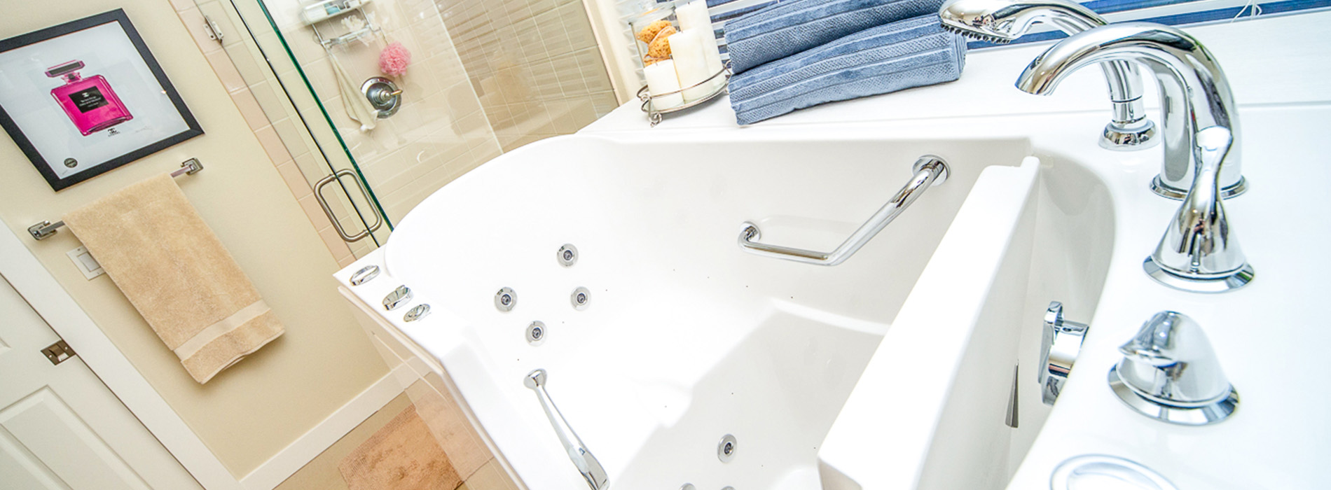 An interior bathroom scene showing a bathtub with faucets and a towel rack.