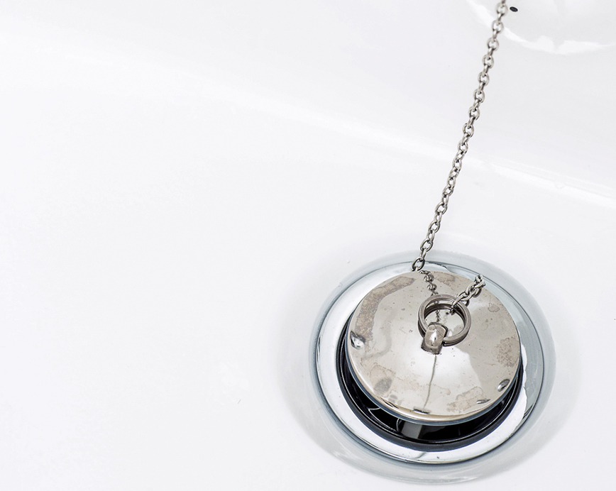 A silver pendant with a reflective surface hanging from a chain against a white background.