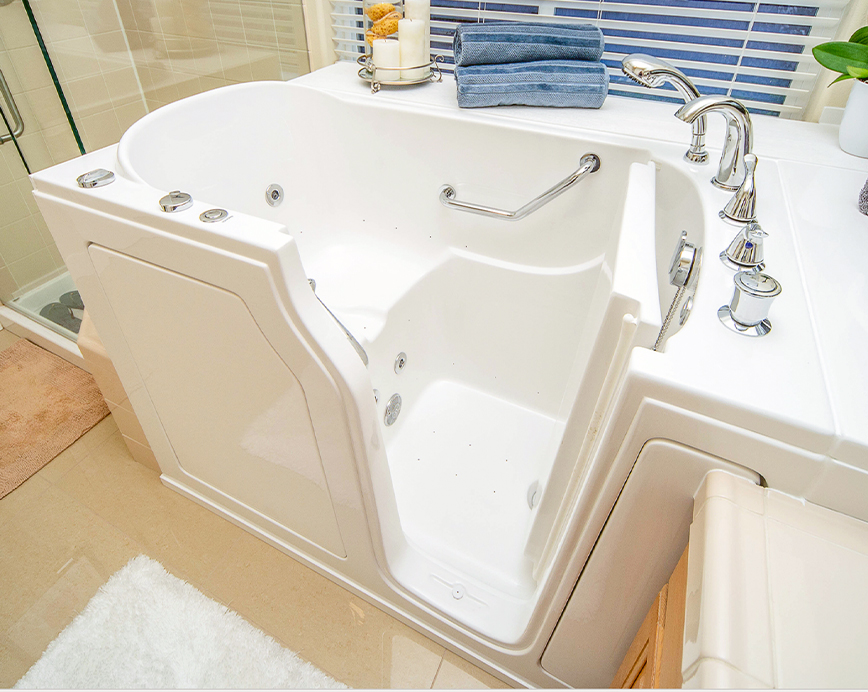 A large, white freestanding bathtub with a clawfoot design, situated in a bathroom.