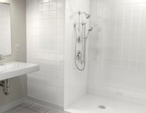 The image shows a pristine, well-lit bathroom with white tiles on the walls and floor, featuring a shower stall with a glass door, a white bathtub, and two sinks with silver faucets, one of which has a mirror above it.