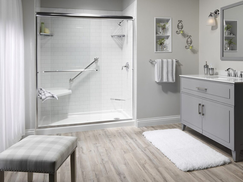 A spacious bathroom with a walk-in shower, double sinks, and a large mirror above the vanity.